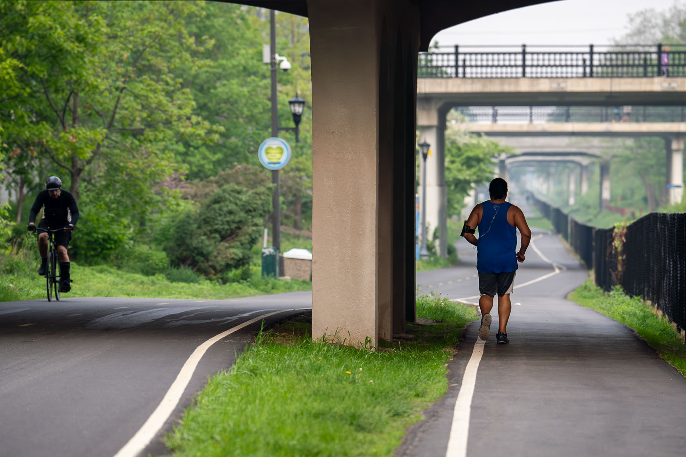 Man and bicyclist on a biking trail with wildfire smoke