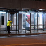 Minneapolis DID worker pressure cleaning a bus stop in downtown Minneapolis.