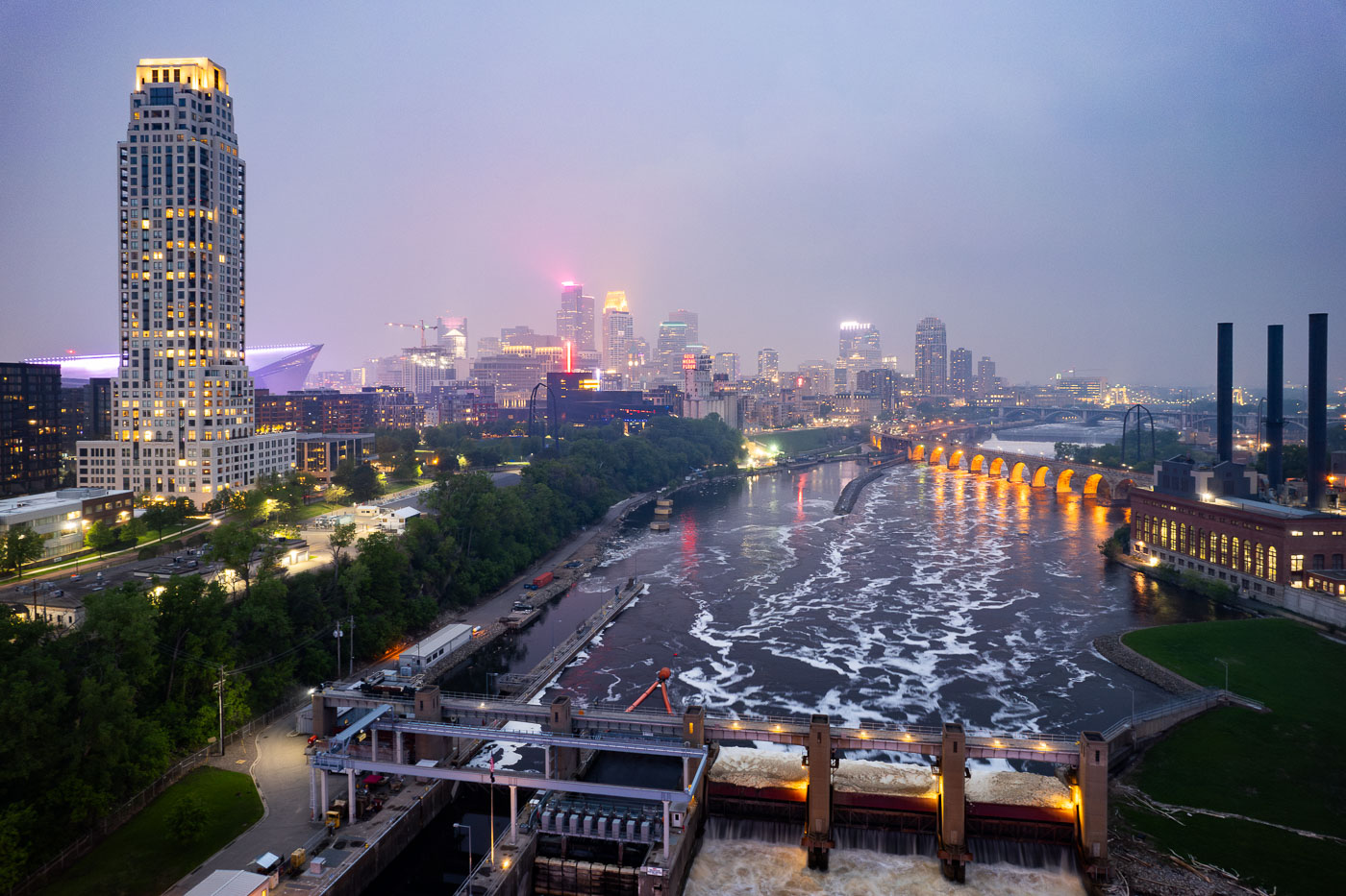 Night photo of river and city skyline with a haze in Minneapolis