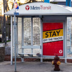 Metro Transit Stay off The Tracks signage on Hennepin Avenue.