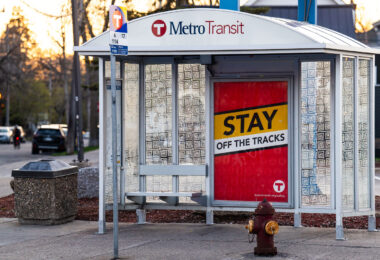 Metro Transit Stay off The Tracks signage on Hennepin Avenue.