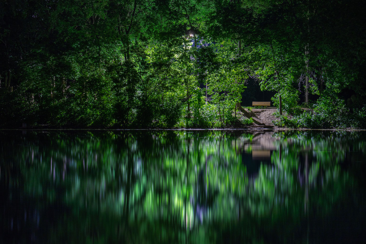 Bench on reflecting Cedar Lake in Minneapolis
