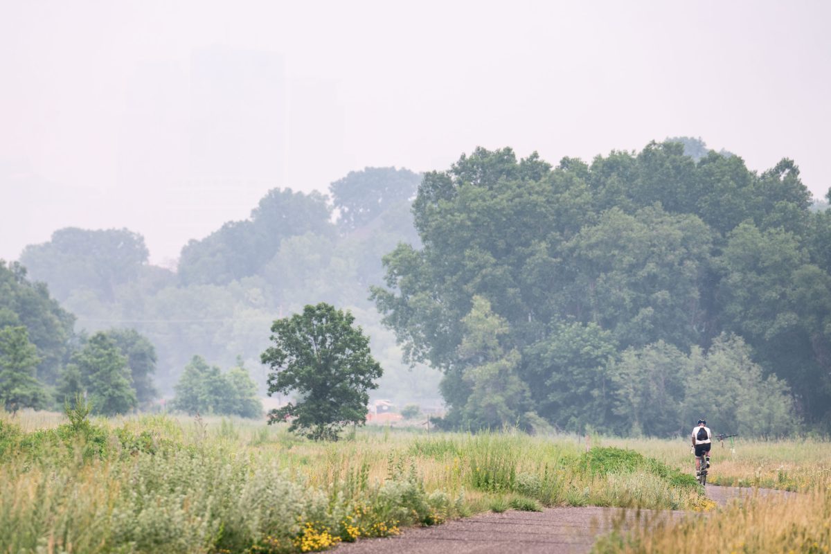 Biker on Cedar Lake Trail during heavy wildfire smoke