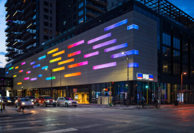 Downtown Minneapolis during pride week. Minneapolis police officers biking by.