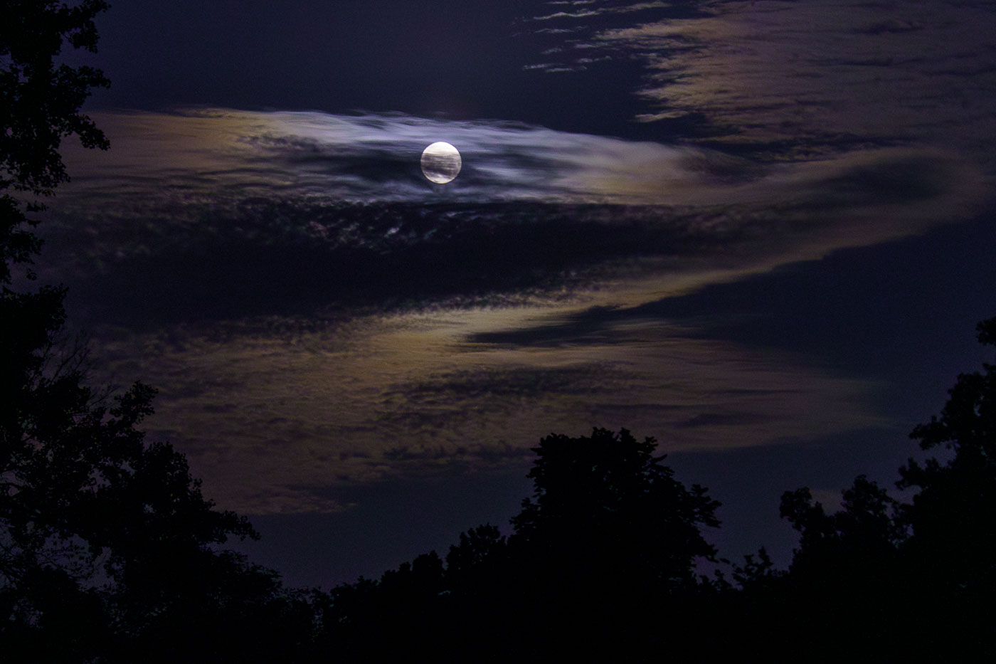 Full moon over Minneapolis with hazy clouds