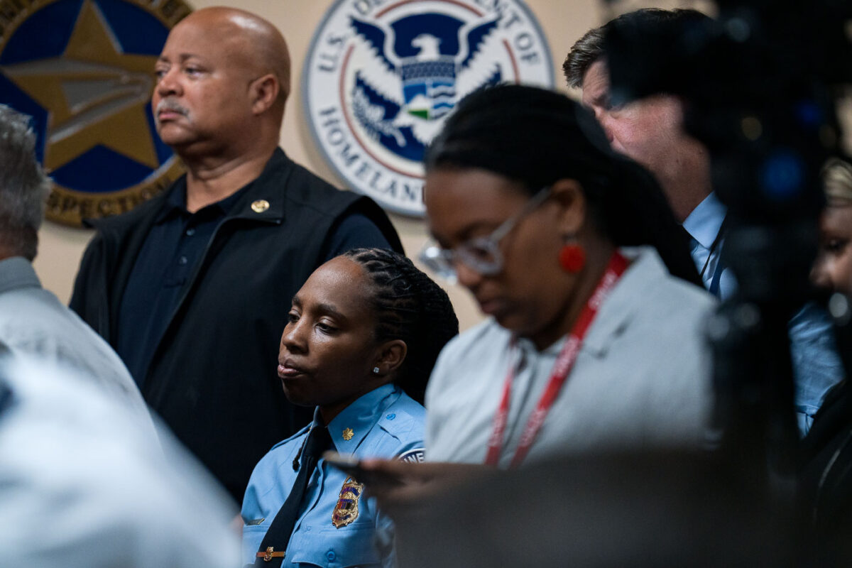 A Minneapolis police officer watches as the Department of Justice announces their findings of an investigation into the Minneapolis police department.