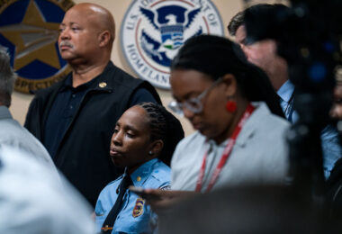 A Minneapolis police officer watches as the Department of Justice announces their findings of an investigation into the Minneapolis police department.