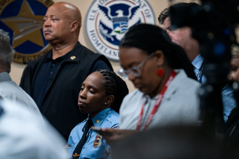 Minneapolis Police Officer at DOJ press conference 1 A Minneapolis police officer watches as the Department of Justice announces their findings of an investigation into the Minneapolis police department.