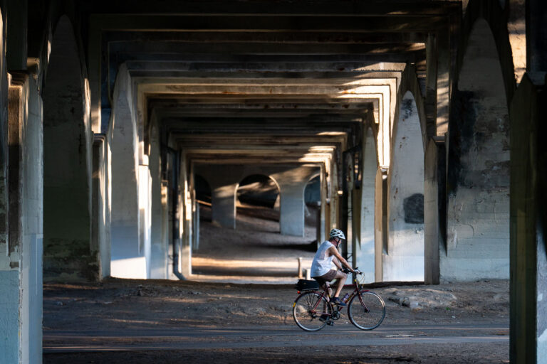 Biker under the bridge in Minneapolis 4 A biker under the Nicollet Ave bridge in Minneapolis.