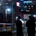 A group looks at the newly installed fence at the end of the Stone Arch Bridge.