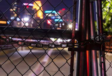 Looking through locked fence of the Stone Arch Bridge. The bridge was closed due to reports of late night crime.