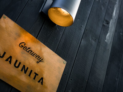 Getaway Jaunita Sign on Dark Wood Wall