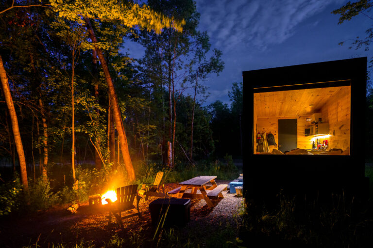 Kettle River Cabin and Campfire at Dusk 4 A modern cabin and campfire are lit at dusk near the Kettle River