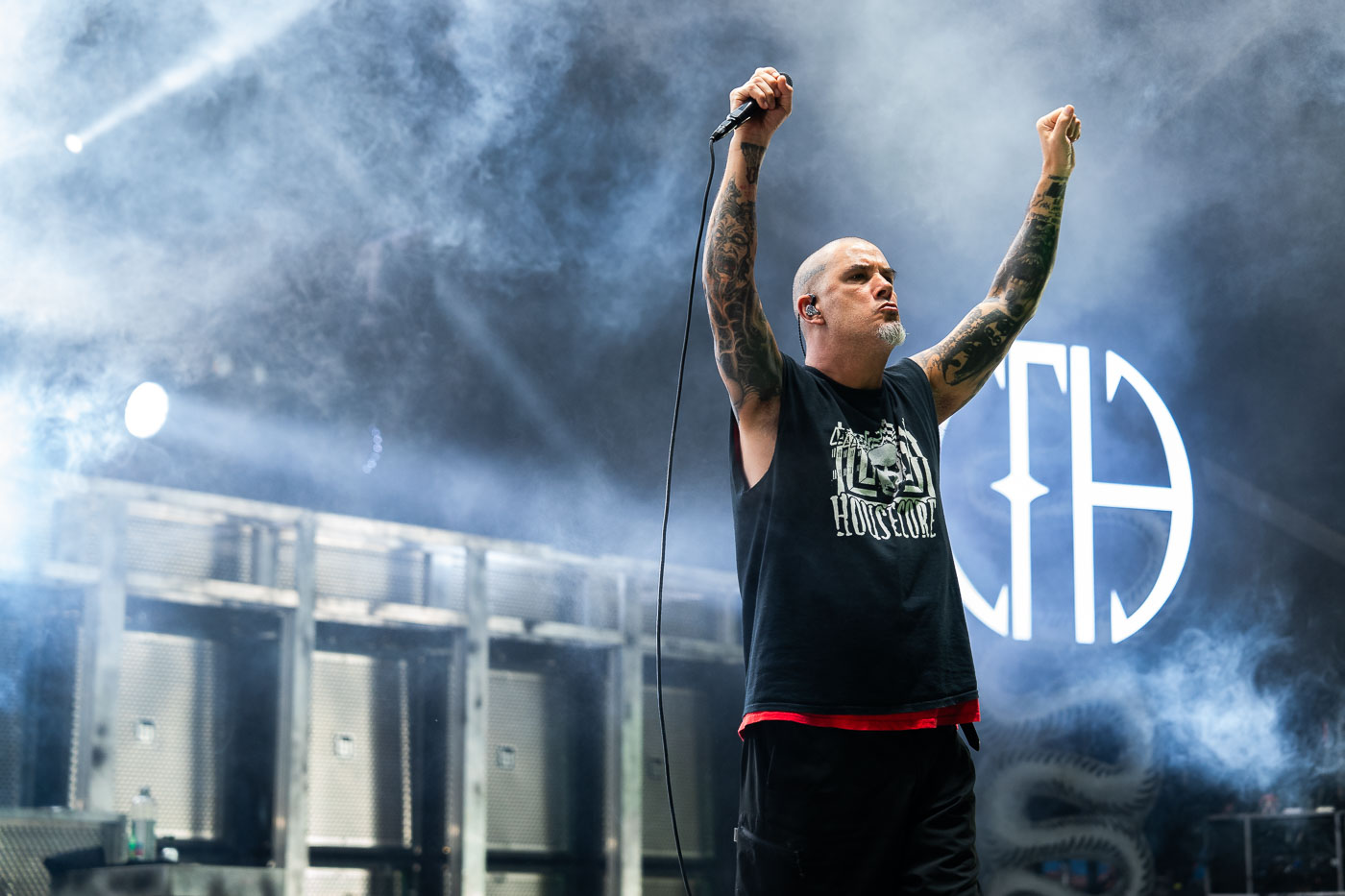 Phil Anselmo, vocalist for the band Pantera, performs at Rock Fest in Cadott, Wisconsin on July 13, 2023. Rock Fest is an annual heavy metal music festival held in Cadott, Wisconsin, a community of approximately 1,200 residents. The festival has grown to become one of the largest outdoor music festivals in the Midwest, attracting tens of thousands of attendees each year. Pantera, a seminal band in the groove metal genre, reunited for a series of performances in 2023, marking a significant moment for fans of the group.