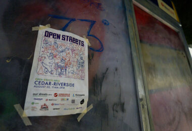 A flyer for Open Streets Cedar-Riverside at a bus stop in South Minneapolis on August 20, 2023.