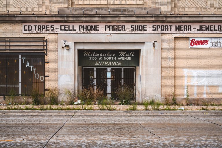 Milwaukee Mall Entrance, 2100 W. North Avenue, Milwaukee 1 Abandoned Milwaukee Mall entrance at 2100 W. North Avenue shows boarded storefront with vintage signage.