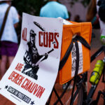 A protester at a rally outside the Hennepin County Courthouse with a sign that reads “All Crops Are Derek Chauvin”. Those at the rally are asking for Hennepin Attorney Mary Moriarty to charge the Minnesota State Trooper Ryan Londregan in the killing of Ricky Cobb II. Cobb was killed on July 31 after being shot during a traffic stop.