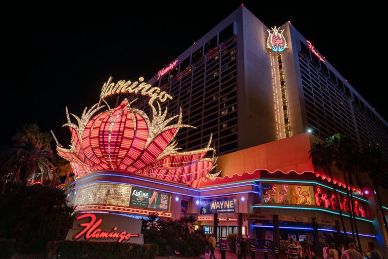 Flamingo Hotel and Casino, Las Vegas at Night 4 The Flamingo Hotel and Casino on the Las Vegas Strip is illuminated at night, featuring neon signage and a tropical theme.