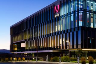 Glass buildings with Adobe logo sign