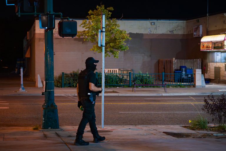 Lake Street Security at Karmel Mall, Minneapolis 3 Private security guard with face mask walking on Lake Street