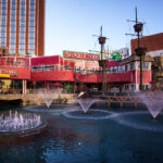 Senor Frog's at Treasure Island Las Vegas 3 The waterfront at Treasure Island features Señor Frog’s, a lively restaurant and bar that overlooks the resort’s lagoon and replica pirate ships. Once home to the “Sirens of TI” show, the area now serves as a social hub with fountains, themed décor, and outdoor seating that captures views of the Las Vegas Strip. The playful red exterior and nautical props recall the property’s original pirate theme, blending nostalgia with the casual, party-friendly energy that defines this corner of the Strip today.