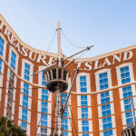 Treasure Island Hotel and Casino in Las Vegas 4 Treasure Island Hotel and Casino, often called “TI,” opened in 1993 on the Las Vegas Strip as a pirate-themed resort developed by Steve Wynn. The property’s signature red and cream façade overlooks a lagoon once home to nightly pirate ship battles—an attraction that became one of the Strip’s most recognizable spectacles. While the resort has evolved over time, moving away from its original family-friendly theme, the nautical elements and ship masts at its entrance remain as nostalgic reminders of its 1990s Las Vegas showmanship.