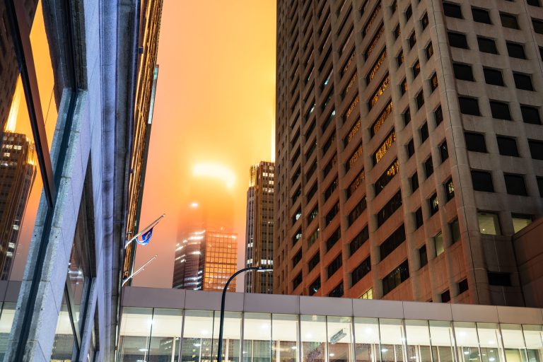 Capella Tower in Fog, Downtown Minneapolis 1 Downtown Minneapolis office buildings and street-level skyway during sunset with orange sky.