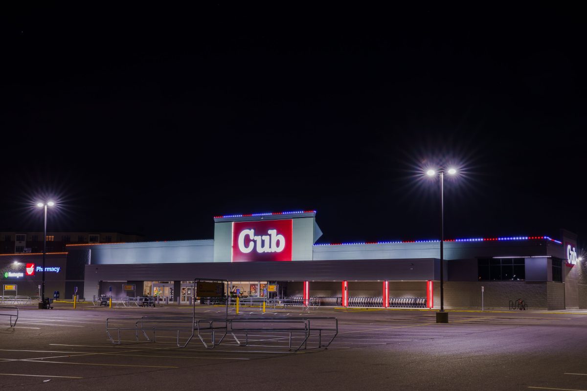 Cub Foods supermarket in South Minneapolis illuminated at night with neon signage and bright overhead lights.