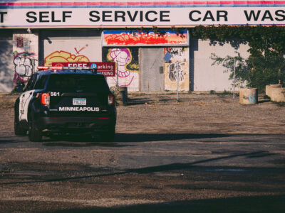 Minneapolis Police Squad Car at Graffiti-Covered Self-Service Car Wash
