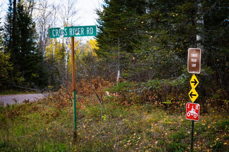Superior National Forest: Cross River Rd & Timber Frear Loop 2 Signs for Cross River Rd and Timber Frear Loop in Superior National Forest, Minnesota, indicate routes for vehicles and ATVs along a gravel road.