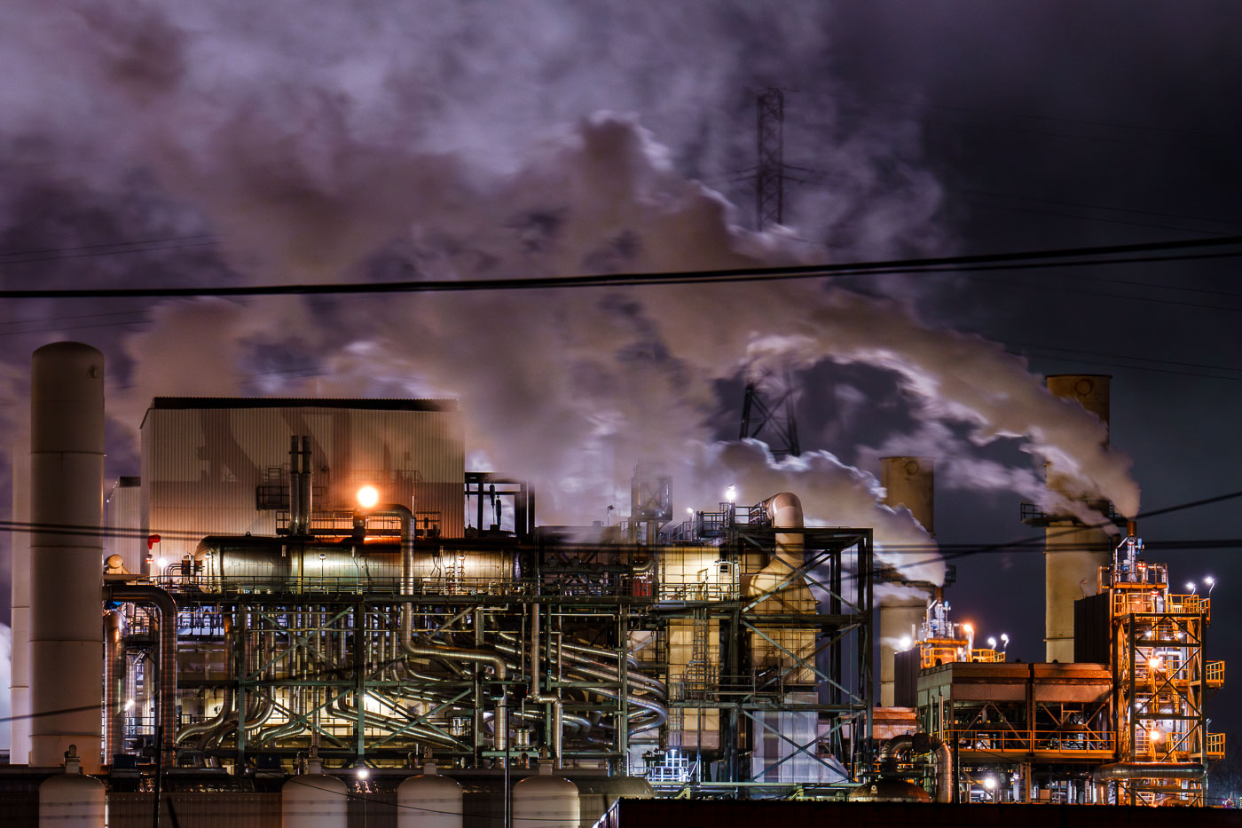 The BP Whiting Refinery in Whiting, Indiana, is the Midwest's largest oil processing facility, featuring extensive piping and distillation columns illuminated at night.