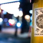 A flyer wheat pasted to a poll in Minneapolis that reads "Ceasefire Now".