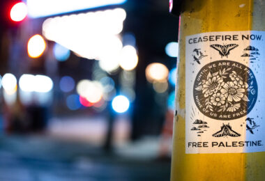 A flyer wheat pasted to a poll in Minneapolis that reads "Ceasefire Now".