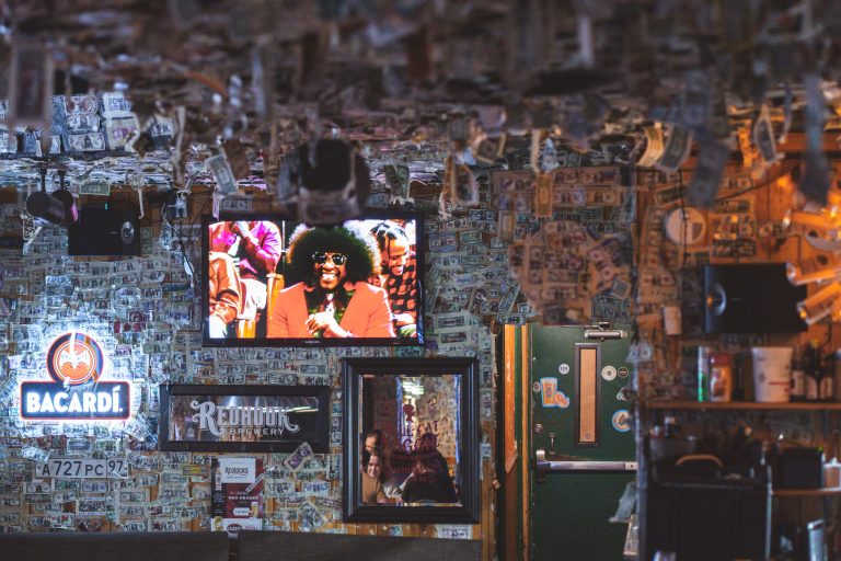 Dollar-Covered Walls at Cuzzy's Bar, North Loop Minneapolis 2 Interior of Cuzzy's Bar in Minneapolis displaying Bacardi signage and collaged dollar bills on walls.
