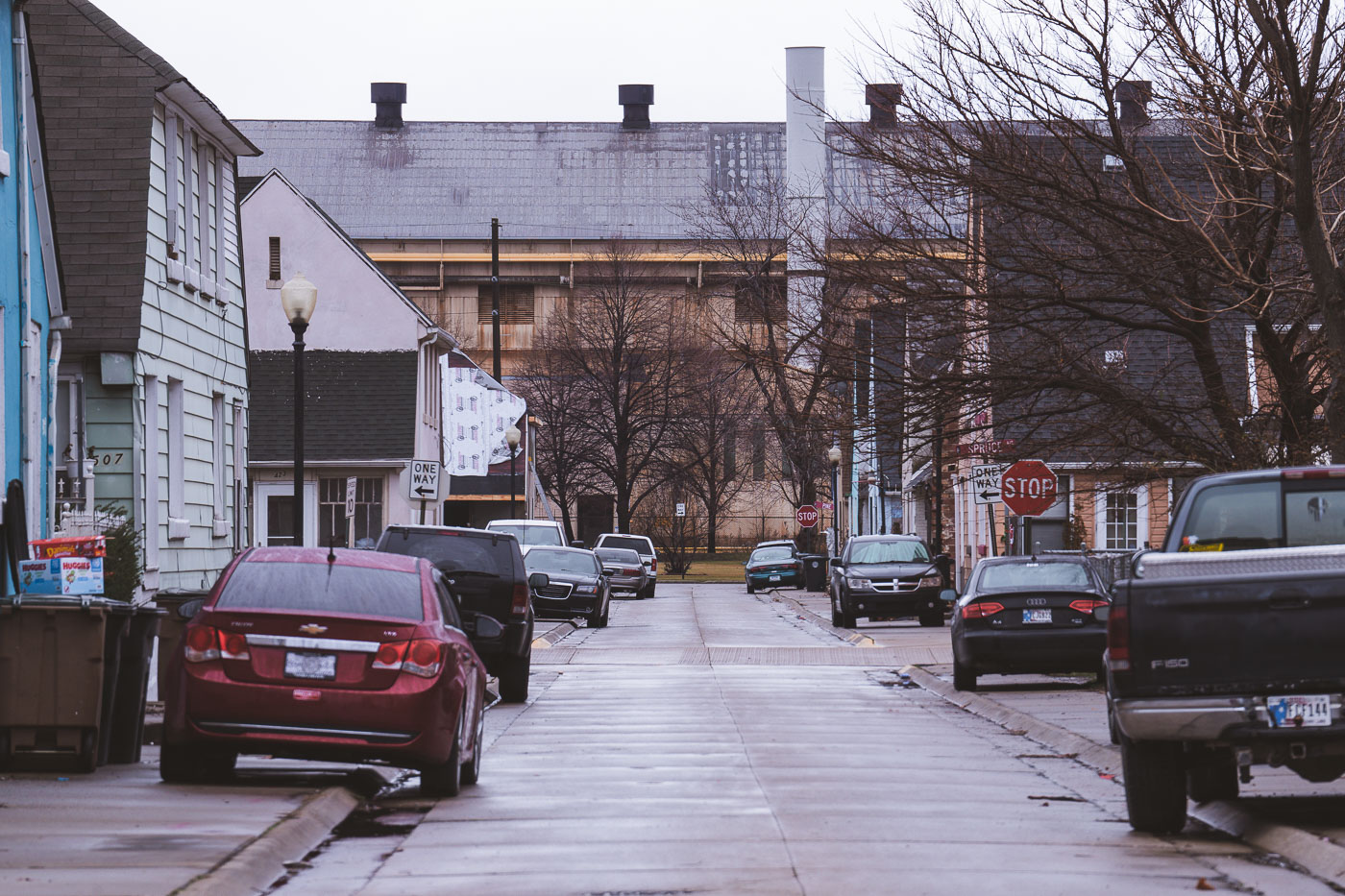 Marktown street in East Chicago, Indiana, with residential buildings and industrial structures characteristic of the area's historical development.