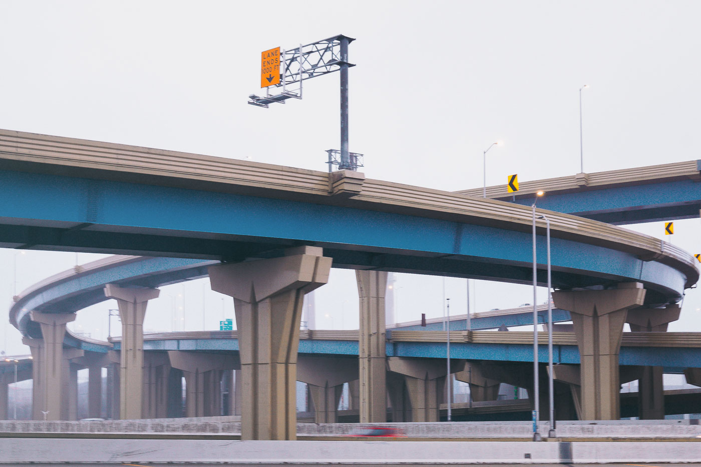 The Marquette Interchange in Milwaukee, Wisconsin, is a complex freeway interchange with elevated ramps and concrete supports, designed to improve traffic flow.