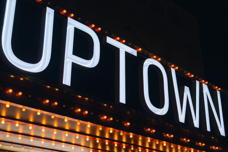 Uptown Theater Marquee, Minneapolis 1 The illuminated Uptown Theater marquee in Minneapolis, featuring large white letters and rows of orange bulbs, is a historic landmark at Hennepin and Lagoon Avenues.
