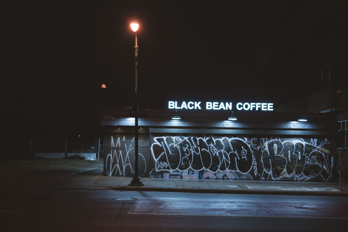 Black Bean Coffee on Chicago Avenue in Minneapolis with graffiti on the front shutters. January 2024.