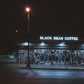 Black Bean Coffee on Chicago Avenue in Minneapolis with graffiti on the front shutters. January 2024.