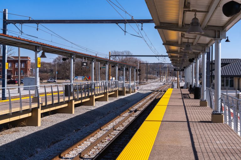 Miller Station Platform in Gary Indiana 3 Empty railroad platform with yellow safety strip and overhead canopy structure.