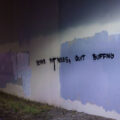 Graffiti on the Midtown Greenway in South Minneapolis that reads "Repair Pot Holes, Quit Buffing Graffiti".