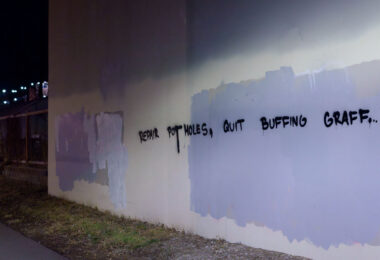 Graffiti on the Midtown Greenway in South Minneapolis that reads "Repair Pot Holes, Quit Buffing Graffiti".