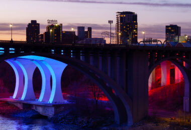 The 10th Avenue and I-35W bridges lit up at sunset near downtown Minneapolis. March 2024.