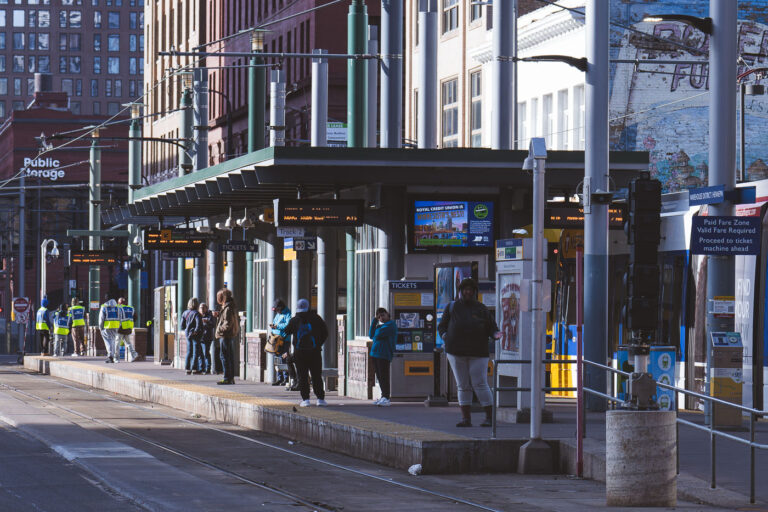 Commuters wait at the Warehouse District Station 1 TRIP Outreach and riders at the Warehouse District/Hennepin Ave Station in downtown Minneapolis. March 2024.