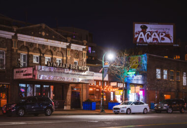LynLake Brewery and a billboard tagged ACAB on Lyndale Avenue in Minneapolis. March 2024.