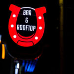 Daisys Bar & Rooftop sign on Hennepin Avenue in front of the McDonalds. The bar replaced another cowboy themed bar "Cowboy Slims".