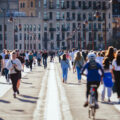 People walking jogging biking on bridge