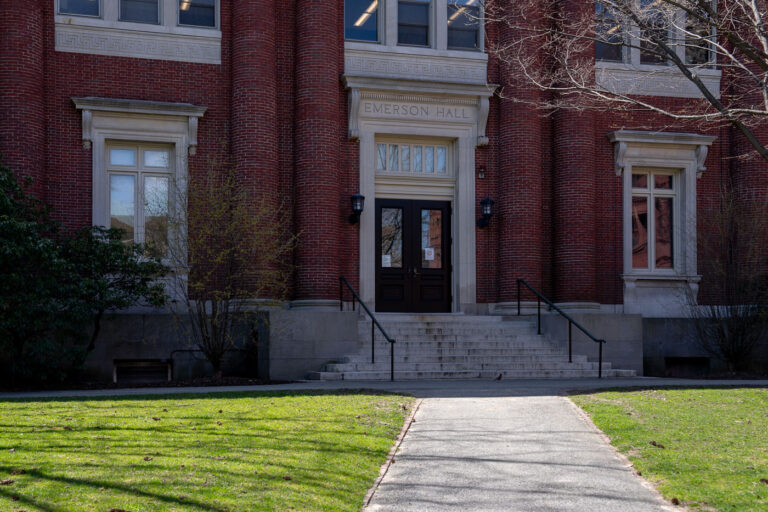 Emerson Hall Entrance, Harvard Yard 1 The neoclassical brick facade of Emerson Hall, located in Harvard Yard, is framed by early spring light in this photograph. Completed in 1900 and designed by Guy Lowell, the building houses Harvard’s Department of Philosophy and is named after transcendentalist writer and alumnus Ralph Waldo Emerson. Its symmetrical design features Ionic pilasters, limestone trim, and a grand central staircase leading to wooden double doors. Emerson Hall stands as a quiet academic landmark amid the historic core of Harvard University, reflecting the campus’s architectural balance between formality and contemplation.