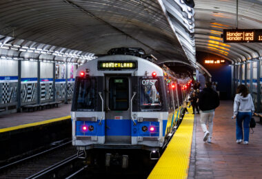 MBTA Wonderland bound train from the Aquarium Station. Passengers on the platform getting on the train.