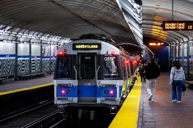 MBTA Wonderland bound train from Aquarium Station 2 MBTA Wonderland bound train from the Aquarium Station. Passengers on the platform getting on the train.